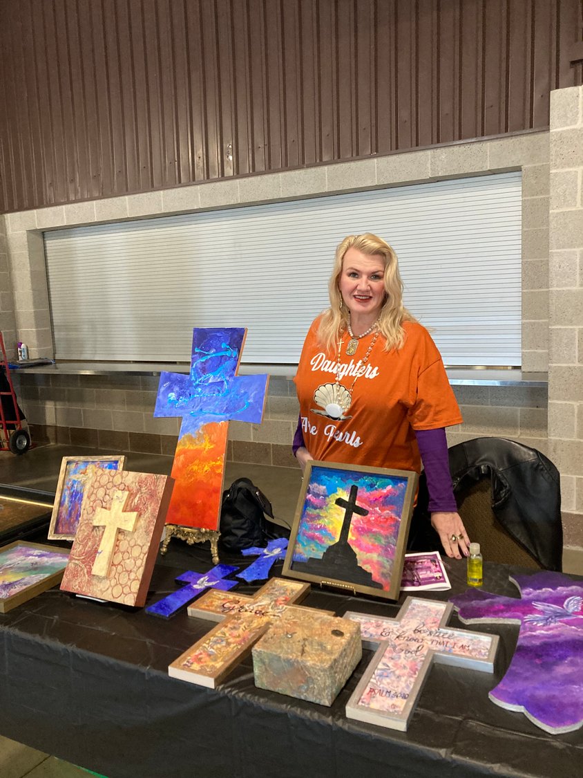 Painter Teresa Staley displays her artwork from Katy, Texas at Saturday’s event hosted by Women Rise Up and Be Encouraged Ministries.